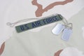 US AIR FORCE branch tape with dog tags on desert camouflage uniform Royalty Free Stock Photo