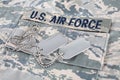 US AIR FORCE branch tape and dog tags on digital tiger-stripe pattern Airman Battle Uniform ABU Royalty Free Stock Photo