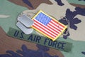 US AIR FORCE branch tape, flag patch and dog tags on woodland camouflage uniform