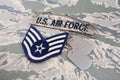 US AIR FORCE branch tape and Staff Sergeant rank patch and dog tags on digital tiger-stripe pattern Uniform Royalty Free Stock Photo