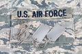 US AIR FORCE branch tape and veteran old type dog tags on digital tiger-stripe pattern Airman Battle Uniform Royalty Free Stock Photo