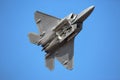 A US Air Force F-22 Raptor performs a demo at airshow with open internal weapon bay