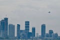 A Lone Thunderbird Flying Above New Condo High-rises Royalty Free Stock Photo