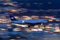 US Airways Airbus A319 airliner on approach to land at night at McCarran International Airport in Las Vegas