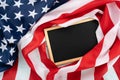 US American flag with blackboard on blue wooden background. For USA Memorial day, Presidents day, Veterans day, Labor day, Royalty Free Stock Photo