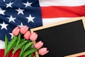 US American flag with blackboard and tulip on white background. For USA Memorial day, Presidents day, Veterans day, Labor day, Royalty Free Stock Photo