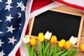 US American flag with blackboard and tulip on wooden background. For USA Memorial day, Presidents day, Veterans day, Labor day, Royalty Free Stock Photo