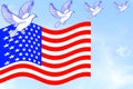 Us or American flag waving in blue sky with dove birds