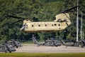 US Army Boeing CH-47F Chinook transport helicopter taking off with UH-60 Blackhawk helicopters in the background. The Netherlands Royalty Free Stock Photo