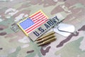 US ARMY branch tape with dog tag flag patch and 5.56 mm rounds on uniform Royalty Free Stock Photo