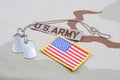 US ARMY branch tape with dog tags and US flag patch on desert camouflage uniform Royalty Free Stock Photo