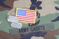 US ARMY CADETS branch tape, flag patch and dog tags on woodland camouflage uniform Royalty Free Stock Photo