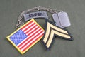 US ARMY Corporal rank patch, sniper tab, flag patch and dog tag on olive green uniform