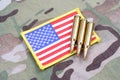 US ARMY flag patch and 5.56 mm rounds on camouflage uniform Royalty Free Stock Photo