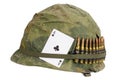 US Army helmet Vietnam war period with camouflage cover and ammo belt and amulet ace of clubs playing card Royalty Free Stock Photo