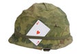 US Army helmet Vietnam war period with camouflage cover and ammo belt and amulet - ace of hearts playing card Royalty Free Stock Photo