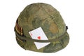US Army helmet Vietnam war period with camouflage cover and ammo belt and amulet ace of hearts playing card Royalty Free Stock Photo
