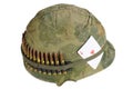 US Army helmet Vietnam war period with camouflage cover and ammo belt and amulet ace of hearts playing card Royalty Free Stock Photo