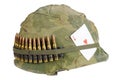 US Army helmet Vietnam war period with camouflage cover and ammo belt and amulet ace of hearts playing card Royalty Free Stock Photo