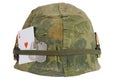 US Army helmet Vietnam war period with camouflage cover and ammo belt and amulet ace of hearts playing card Royalty Free Stock Photo