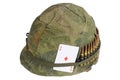 US Army helmet Vietnam war period with camouflage cover, ammo belt and amulet playing card ace of diamonds Royalty Free Stock Photo