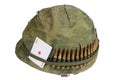 US Army helmet Vietnam war period with camouflage cover, ammo belt and amulet Royalty Free Stock Photo