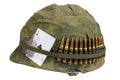 US Army helmet Vietnam war period with camouflage cover and ammo belt, dog tag and amulet Royalty Free Stock Photo