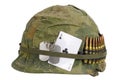 US Army helmet Vietnam war period with camouflage cover and ammo belt, dog tag and amulet ace of clubs playing card Royalty Free Stock Photo