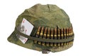 US Army helmet Vietnam war period with camouflage cover and ammo belt, dog tag and amulet ace of hearts playing card Royalty Free Stock Photo