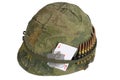 US Army helmet Vietnam war period with camouflage cover and ammo belt, dog tag and amulet ace of hearts playing card Royalty Free Stock Photo