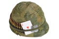 US Army helmet Vietnam war period with camouflage cover and ammo belt, dog tag and amulet Royalty Free Stock Photo