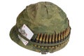 US Army helmet Vietnam war period with camouflage cover and ammo belt, dog tag and amulet Royalty Free Stock Photo