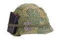 US Army helmet Vietnam war period with camouflage cover, magazine with ammot and dog tags Royalty Free Stock Photo