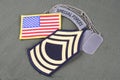 US ARMY Master Sergeant rank patch, airborne tab, flag patch and dog tag on olive green uniform