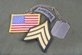 US ARMY Sergeant rank patch, airborne tab, flag patch and dog tag on olive green uniform