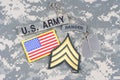 US ARMY Sergeant rank patch, ranger tab, flag patch, with dog tag on camouflage uniform