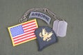 US ARMY Specialist rank patch, airborne tab, flag patch and dog tag on olive green uniform Royalty Free Stock Photo