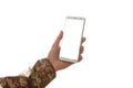 Young soldier holding a mobile phone with blank screen on white background