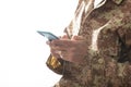 Young soldier holding a mobile phone standing on white background Royalty Free Stock Photo