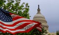 The US Capitol building with a waving American flag superimposed on the sky