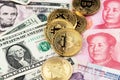 Bitcoin Cryptocurrency coins and US Dollar and Yuan China currency banknotes.