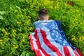 US citizen covered himself with the flag of USA in the bosom of nature