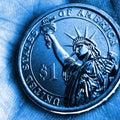 US coin lies on the palm. Blue tinted square illustration. Economy and finance. 1 one dollar coin close-up. The Statue of Liberty