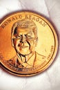 US coin lies on the palm. Obverse coins featuring President Reagan. American political system, presidential elections. Republican