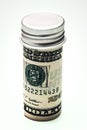 US Dollar banknotes with a bottle lid