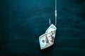 US 100 dollar bill as a bait. American currency on the hook. Investment risk or money trap, business fraud and cheating Royalty Free Stock Photo