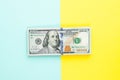 100 US dollar bill money cash on blue and yellow background. Heap of hundred American Dollars banknote Royalty Free Stock Photo