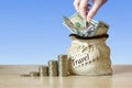 US dollar bills in Bag with coins Stack on table, blur background. Concept of money saving on travel