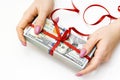 US dollars gift. Money cash with red ribbon and bow in women`s hand Royalty Free Stock Photo