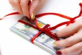 US dollars gift profit. Money cash with red ribbon and bow Royalty Free Stock Photo